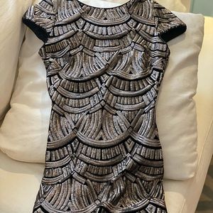Short sequin dress with open back. New with tags